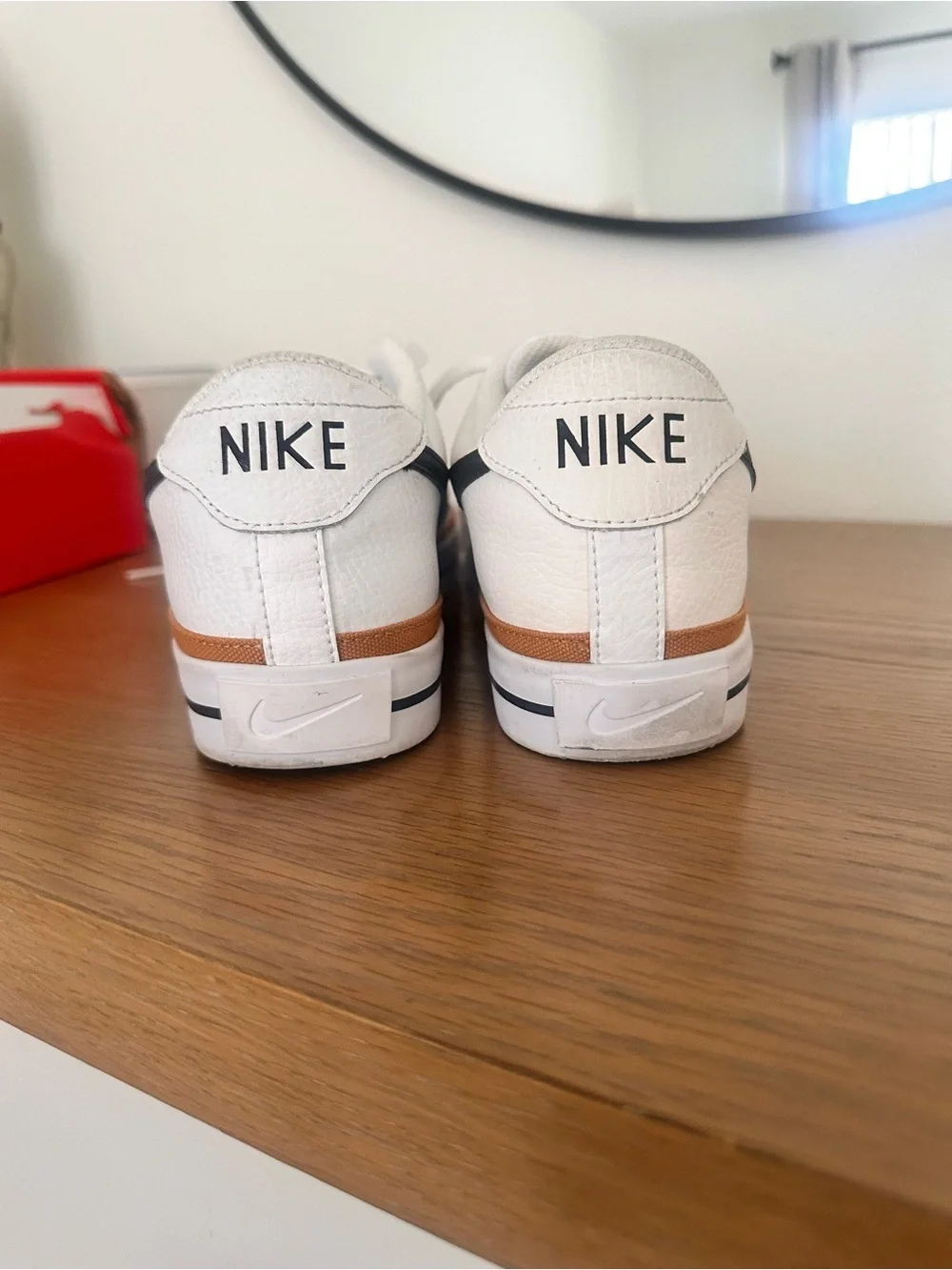 Nike White Low-Top Sneakers with Black Swoosh and Brown Trim